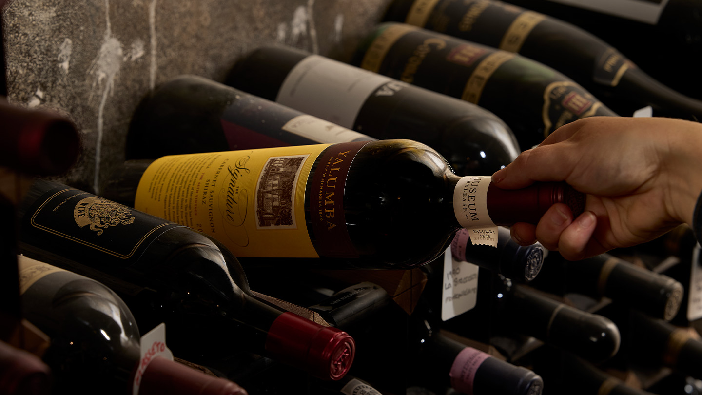 A shot of our museum, as a hand takes out a bottle of The SIgnature.