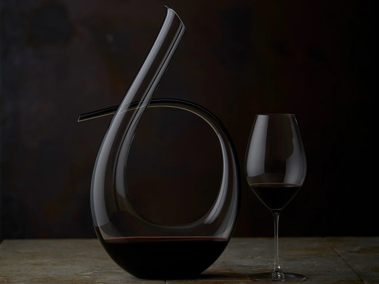 A glass of The Octavius sitting next to it's decanter