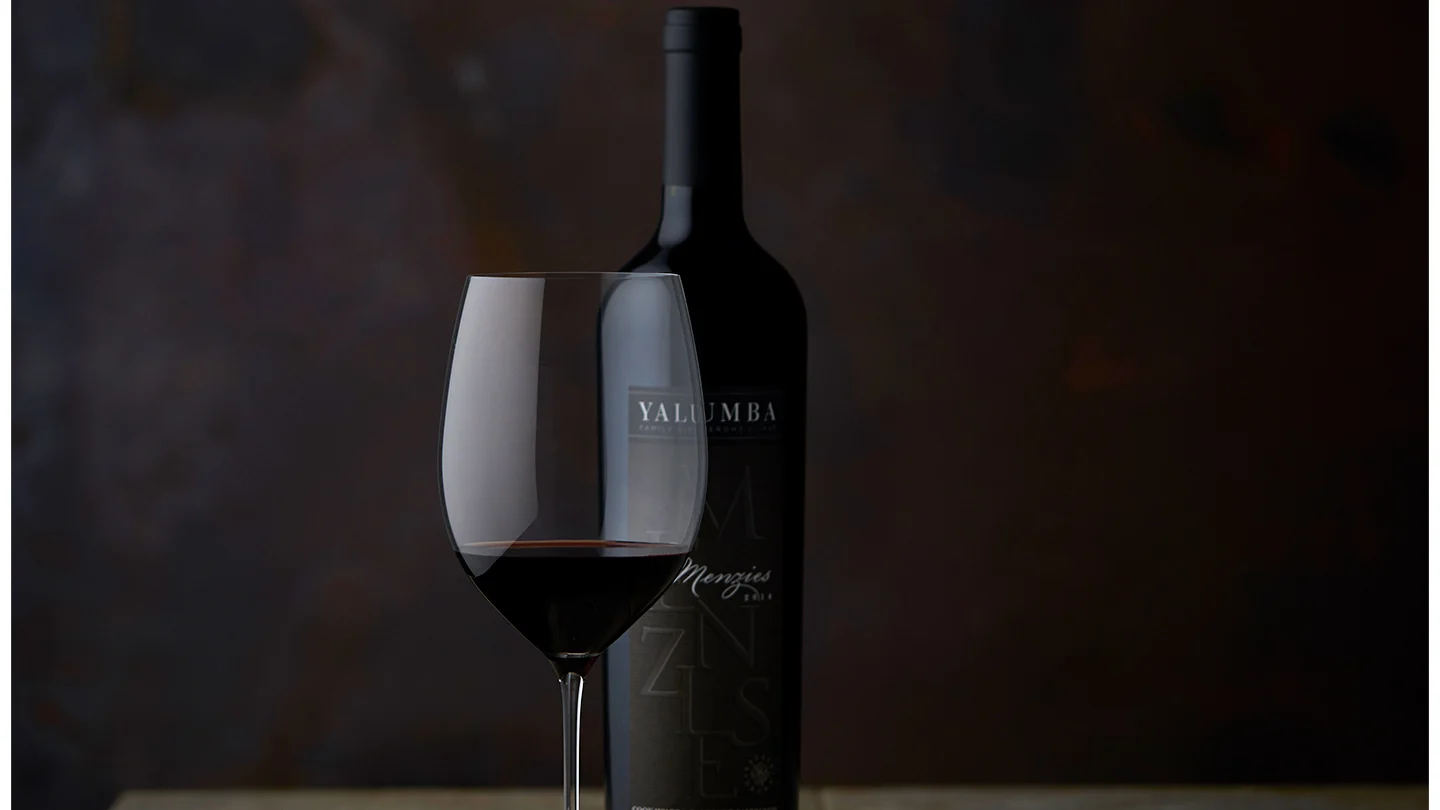 A glass of 175th Anniversary Release sitting in front of the bottle